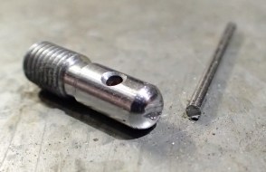 The first thing done was to hacksaw off the superfluous shank to the pin vice. Then a T piece grip was produced by cutting a short titanium peg down to 55mm, cleaning sawn edges with a file to produce the sewing awl