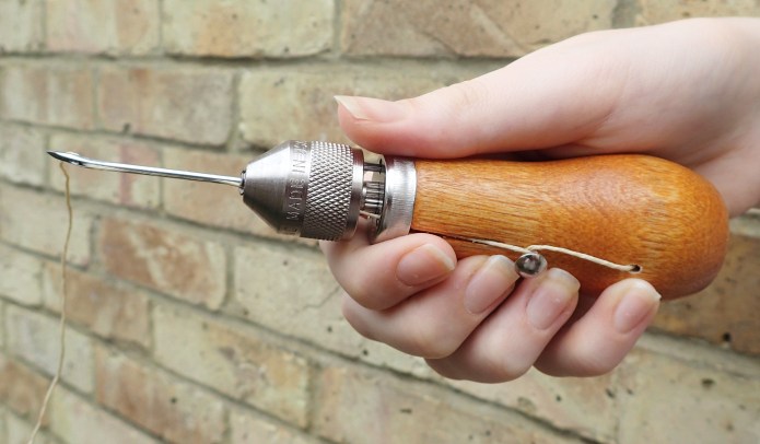 Speedy Stitcher Sewing Awl, with coarse four filament thread and No. 130B- 8C curved needle for more awkward sewing spaces