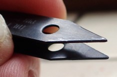 Black anodised tweezers also have faint serrations