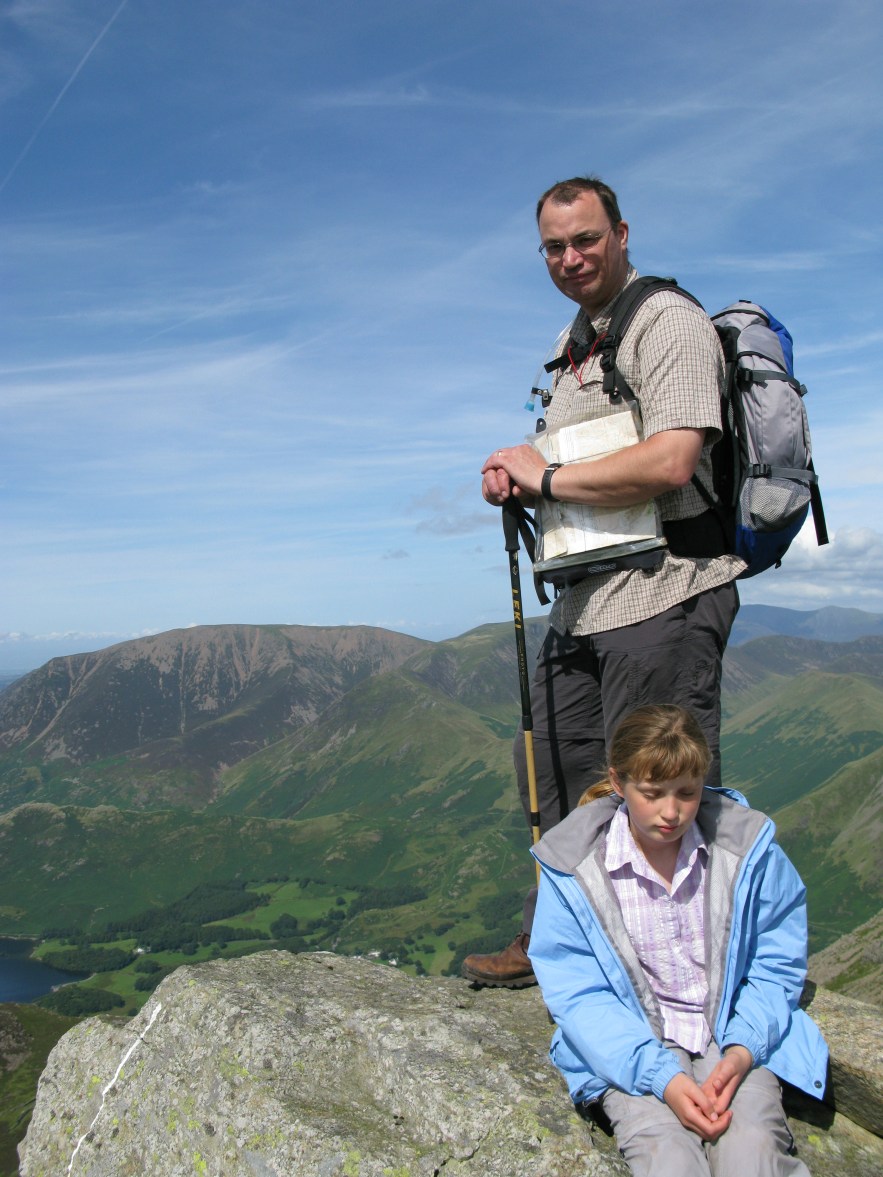 Disheartened daughter cannot work out why Ordnance Survey maps keep leading her father up to the top of hills. Lake District, again, 2009