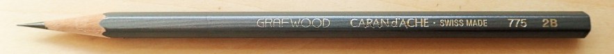 The understated Swiss made Caran d'Ache Grafwood pencil is a good choice. Each pencil is a different shade of pencil to reflect its grade of graphite. If taking a number of these, this makes it easier to select the desired grade at a glance. This is a 2B