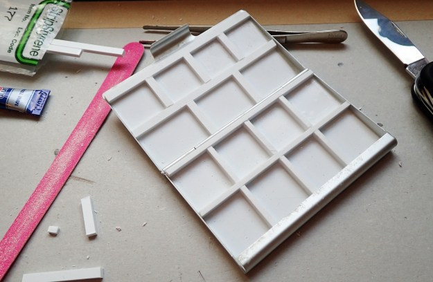 Half an hour playing around with plastic strips and superglue can produce a quite nice bespoke palette, with exactly the size and number of wells required