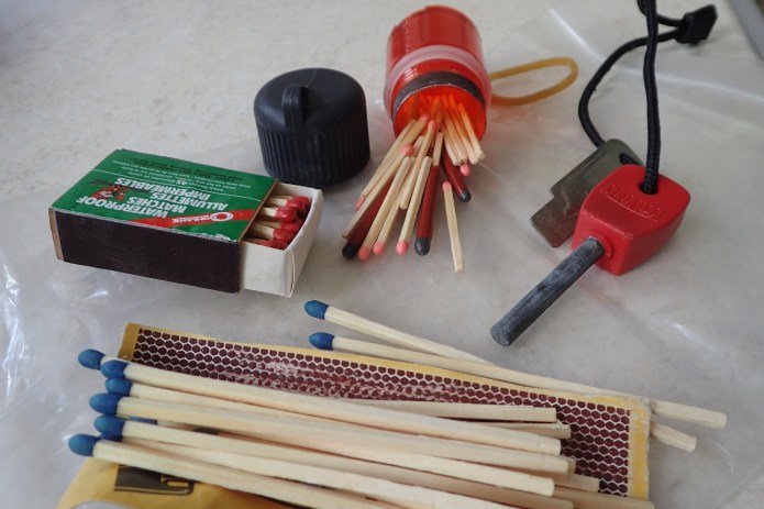 For most short trips, matches will do just fine for fire making. Be they waterproof (sic) or long 'cooks' matches. All are OK unless there is any sort of breeze. Lifeboat matches, with their extra long, varnish dipped, heads will continue to burn in wind and rain. However they are an expensive option. I like using a flint and steel, but this can be a right pain when meths is cold. For longer trips, something that will light hundreds of times is required and matches are only useful as back-up