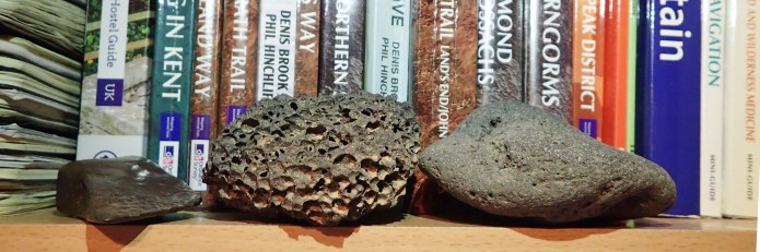 Rocks and other found objects sit on the bookshelves of Three Points of the Compass, each prompts a memory