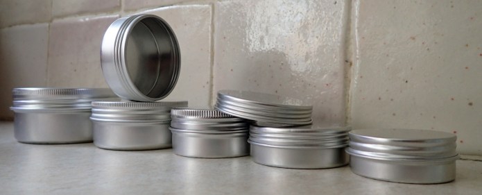 Small aluminium screw top tins are easily available. These are fives of the many sizes on the market. 15ml- 4.5g, 25ml- 6.3g, 30ml- 7.6g, 50ml- 10.1g and 80ml- 14.3g. They can be easily dented and knocked around due to their thin metal, but still hold up well