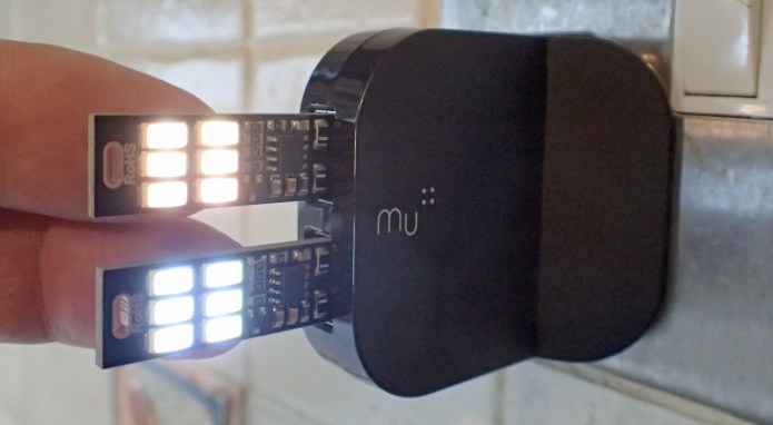 Two 6-LED lights plugged into a two-port Mu wall plug. These are on their lowest brightness. The lights can be switched on and off, or brightness changed, by lightly touching the back of the LED