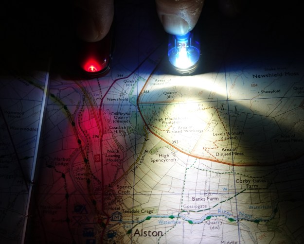The earlier red LEDs, shown here in Midnight Manager, were later replaced with brighter white LEDs, also shown here in a Midnight Manager. White headtorches are carried by most hikers and Three Points of the Compass feels the small red LED is of more use in conjunction with the main white light