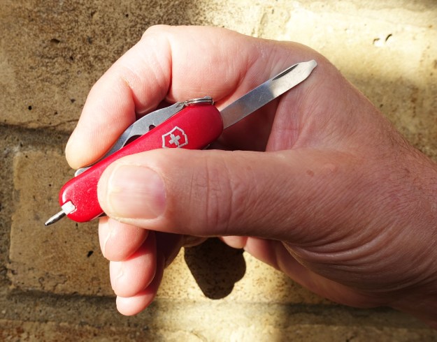 Victorinox Talisman in the hand with ball-point pen extended. Opening the nailfile makes the small 58mm long knife more comfortable in the hand for writing with