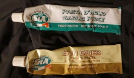 Tubes of tomato and garlic puree are easily found in most supermarkets. Garlic puree is 55% garlic and remainder mostly sunflower oil. Tomato puree is 65% tomatoes and the remainder different oils and flavourings