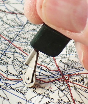 Simple to use, the little wheel is trundled along a line on a map, clicking every quarter mile