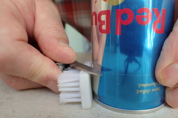 Inverting the can and placing my plastic block on it's long edge, another line is scored