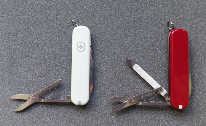 Scissors on 74mm Victorinox Ambassador and Executive knives compared. The thicker Executive has an additional tool nested with the scissors