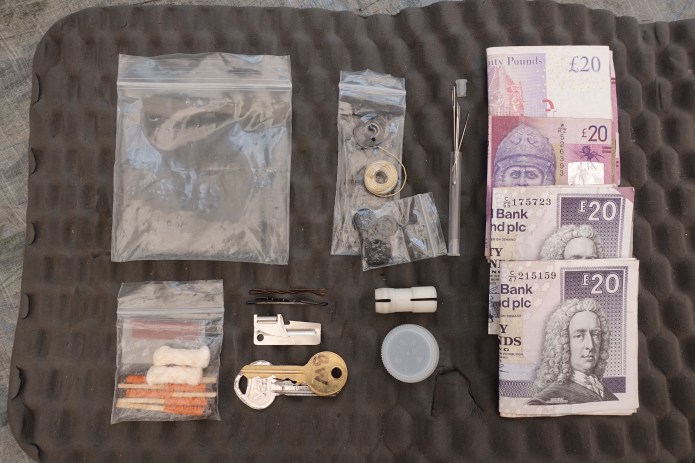 Some of the contents of my backpacking ditty bag- Money, sewing kit, house key and British Waterways water key, emergency fire starter kit, spare water bottle cap, hair grips, to be used as clothes pegs, and a small tin opener