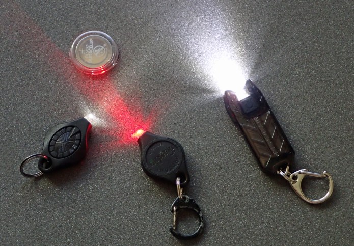 White and red LED Photon Freedom and one spare button battery weighs more than the Nitecore Tube v2