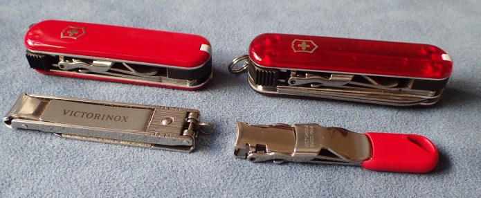 Four Victorinox nail clippers, two with traditional scales, two without