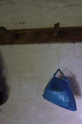 Quilt cord used to hand food bag away from rodents in bothy on South West Coast Path