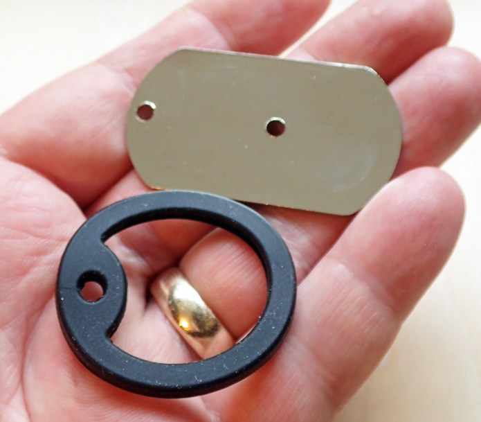 Metal 'dog tag' mirror with superfluous rubber surround ring removed