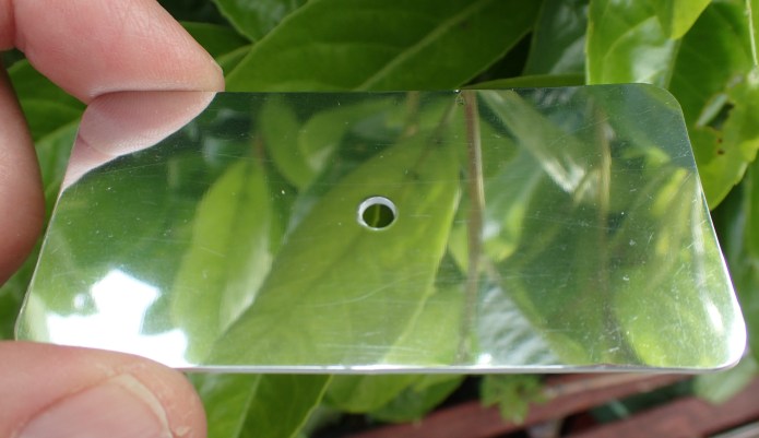 Lightweight acrylic mirror with small sighting hole