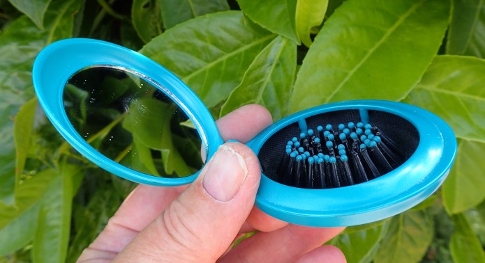 Clamshell hairbrush with small glass mirror