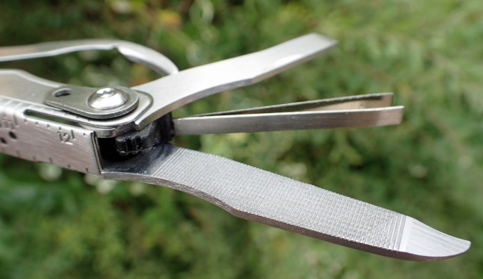 Flat screwdriver, tweezers and nail file