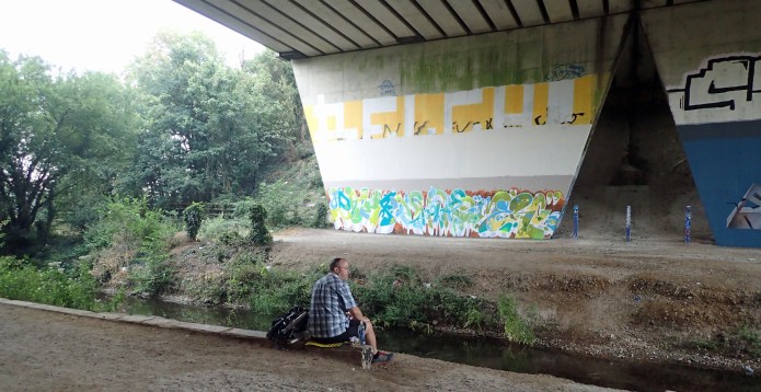 Sitting beneath a road bridge waiting for the rain to pass