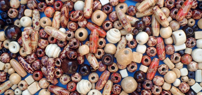 Pearced wooden beads for hair braiding can be purchased very cheaply