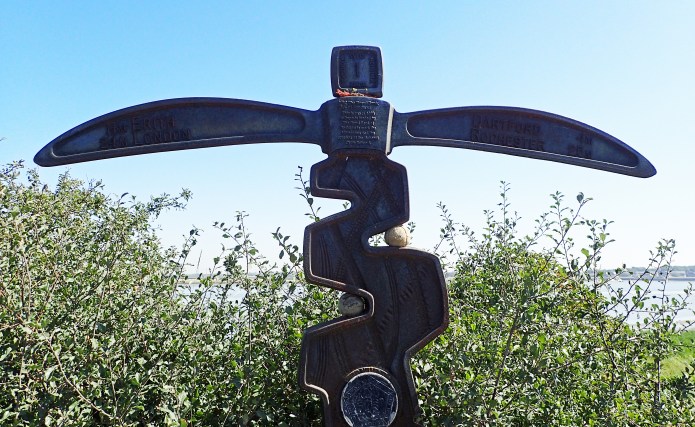 'Tracks' milepost at Dartford on the Thames River Path is badly in need of a repaint and is almost entirelyy taken over by plant growth. But still an ideal location for lost dog's balls apparently