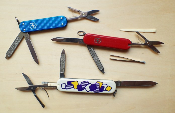 Victorinox Classic SD with three main folding tools and two scale tools open and exposed. Together with the Alox Classic SD, that has no scale tools, and the slightly larger Victorinox Ambassador, that has the same tools as the Classic, but larger