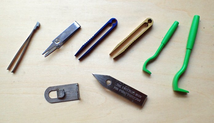 Left to right- tweezers from Victorinox Classic, tweezers from a 'pound shop' glasses care pack, two sizes of titanium tweezers off eBay, with Uncle Bill's Sliver Gripper tweezers below, and two sizes of dedicated tick tweezer