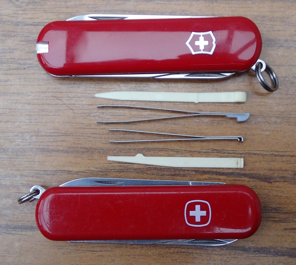 Larger Victorinox toothpick and tweezers compared to the smaller Wenger scale tools