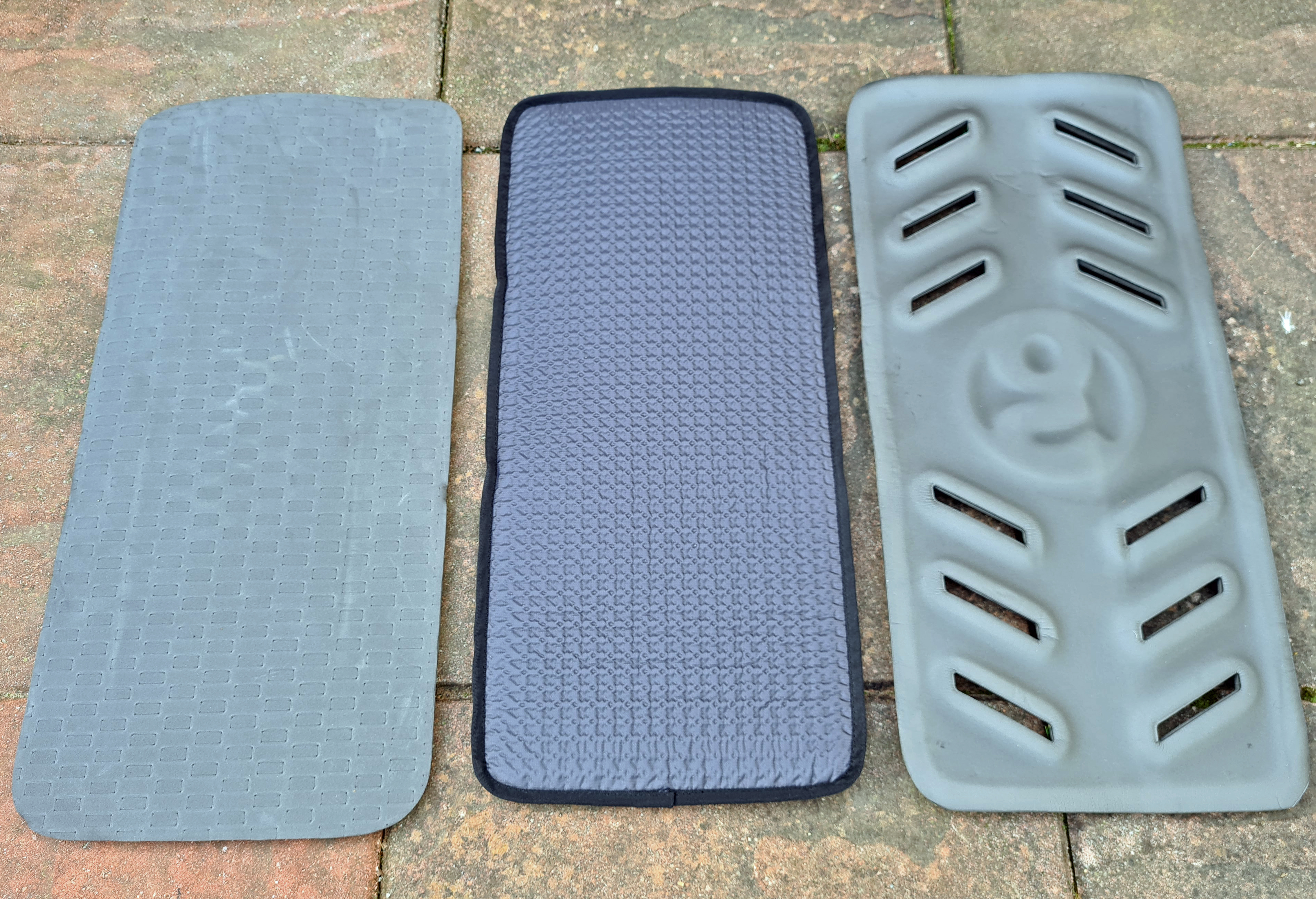 Reverse of three Gossamer Gear sit pads compared