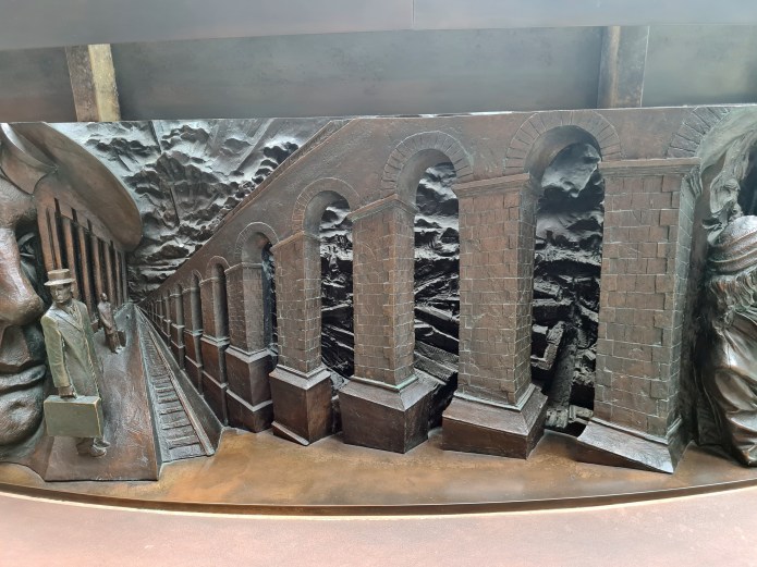 Detail from bronze relief frieze of The Meeting Place