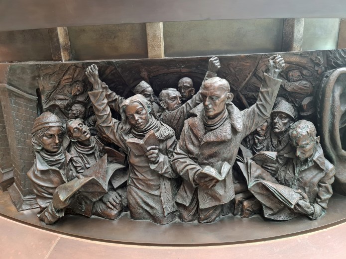 Detail from bronze relief frieze of The Meeting Place