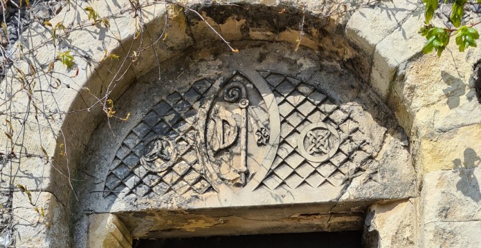 Arch above ancient door entrance to the gardens of Davington Priory