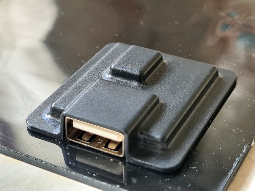 USB Connector block is exposed to the elements, and simply hot-glued to the rear of the panel
