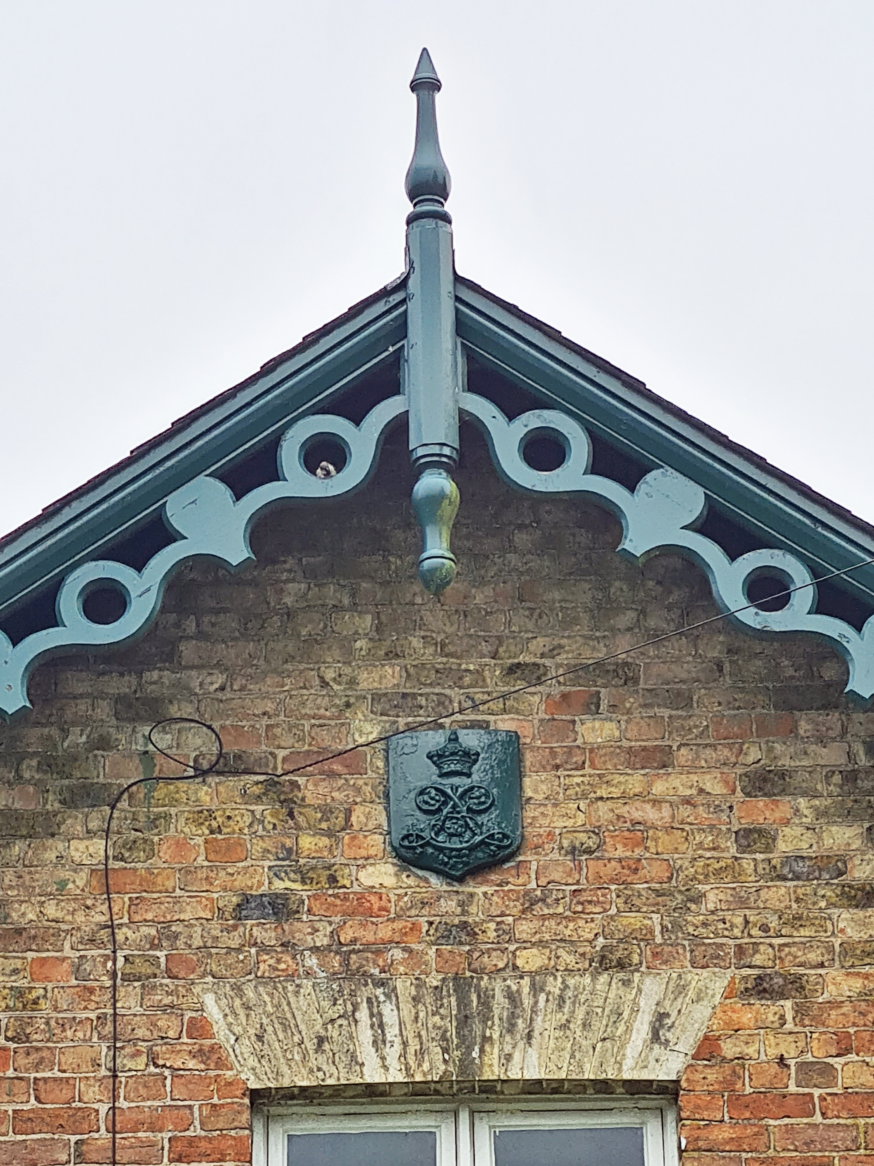 Cottages, built 1860 and once estate workers houses, have the Londesborough cipher on their ends