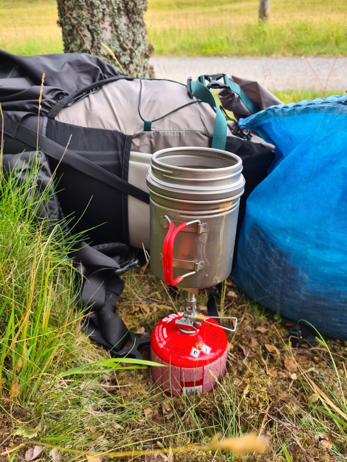The Soto Windmaster is a tall stove. Despite being designed to handle wind admirably, it is usually pretty easy to provide a little more shelter. Brewing up on the Speyside Way