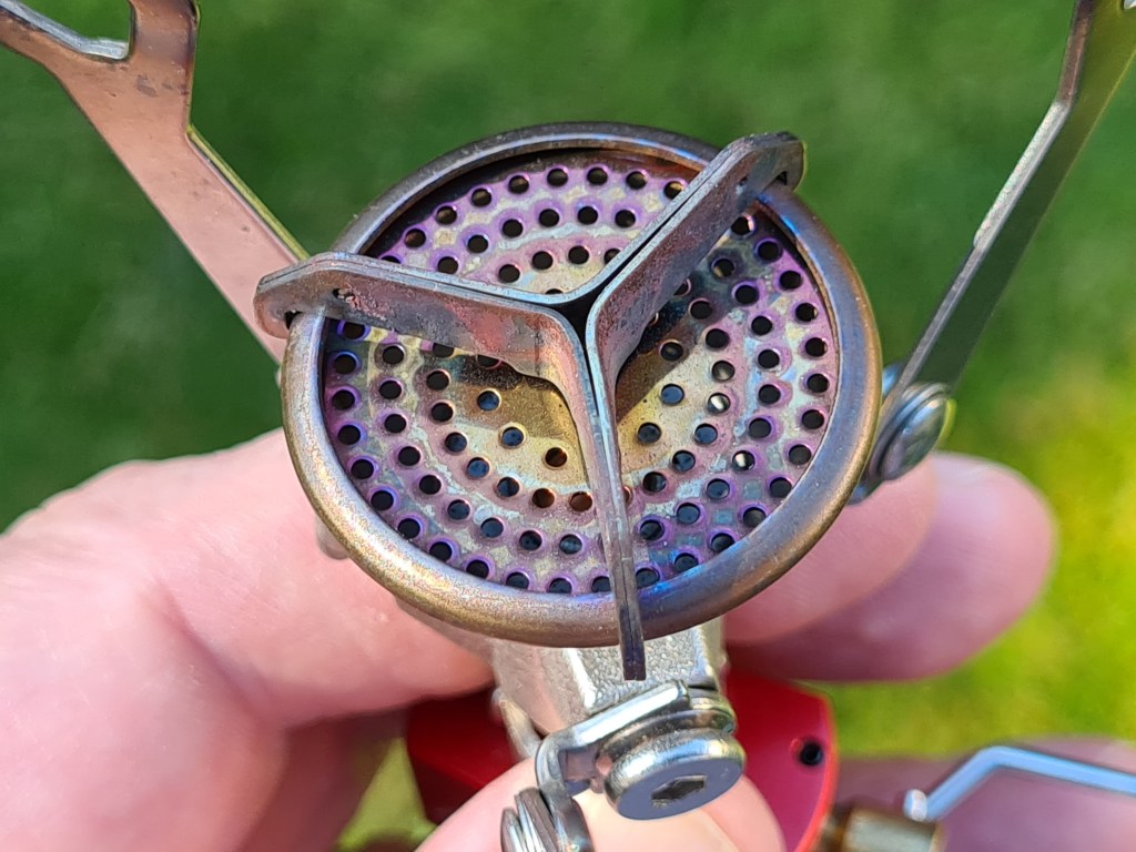 Three-armed WindClip on burner head of MSR Pocket Rocket 2