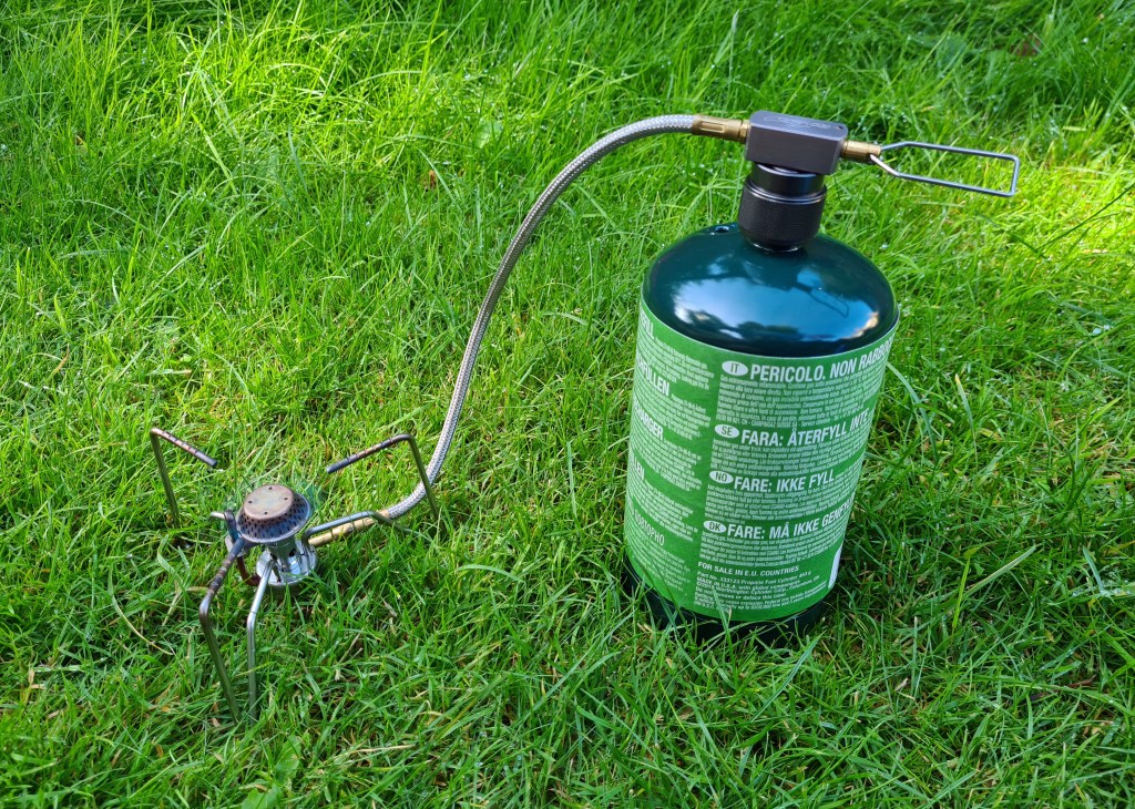 Kovea Spider remotely attached to propane canister with connection adapter