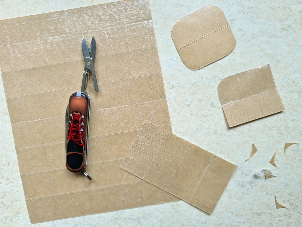 I sourced some adhesive DCF repair tape from Wild Sky Gear and cut this into eight squares roughly 30mm across and gave each corners. This helps them resist peeling when applied.