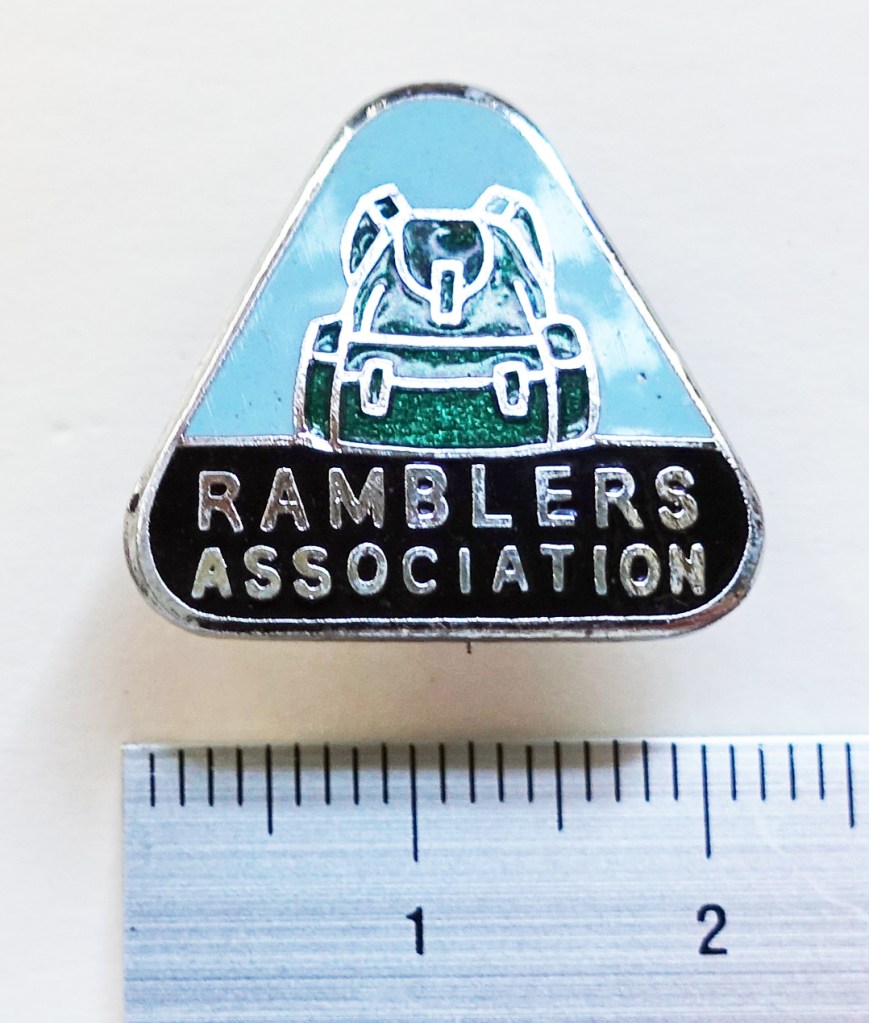 Ramblers Association badge,. 1950’s - 1987. Enameled green Bergan rucksack above 'Ramblers Association' sans apostrophe. Chromium plated, enamelled