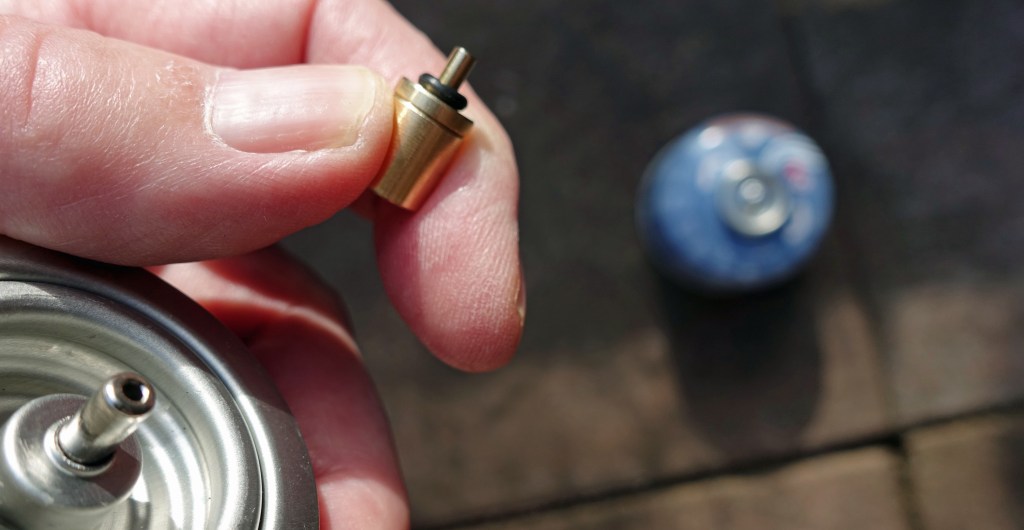 The necessary tool to transfer gas from a cartridge to a canister