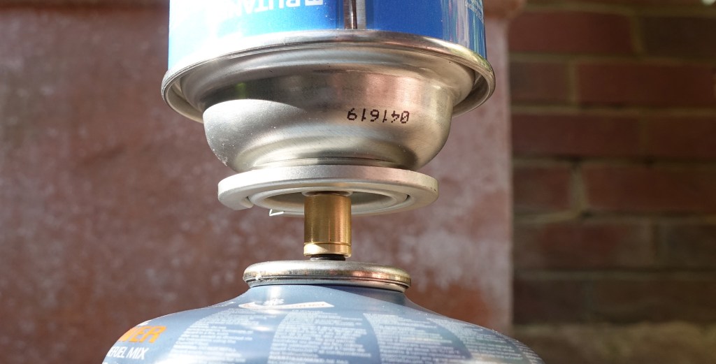 Firmly press and hold the donor cartridge down while the liquid gas transfers