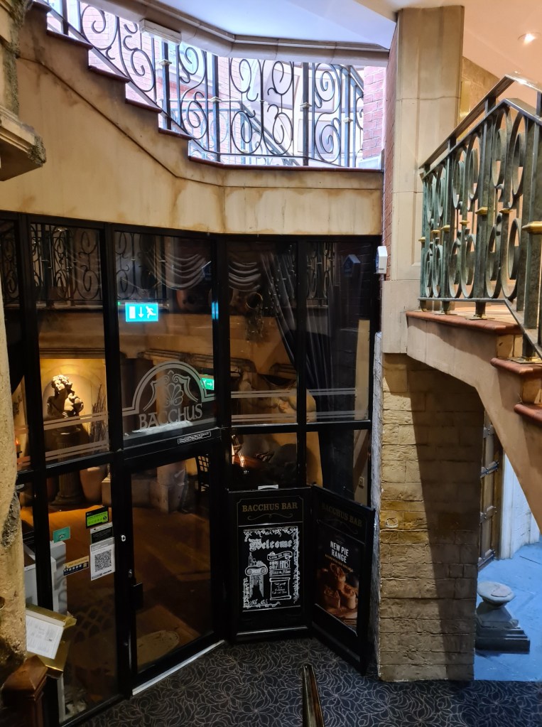 Entrance to the Bacchus Bar is tucked away downstairs beneath the Burlington Hotel