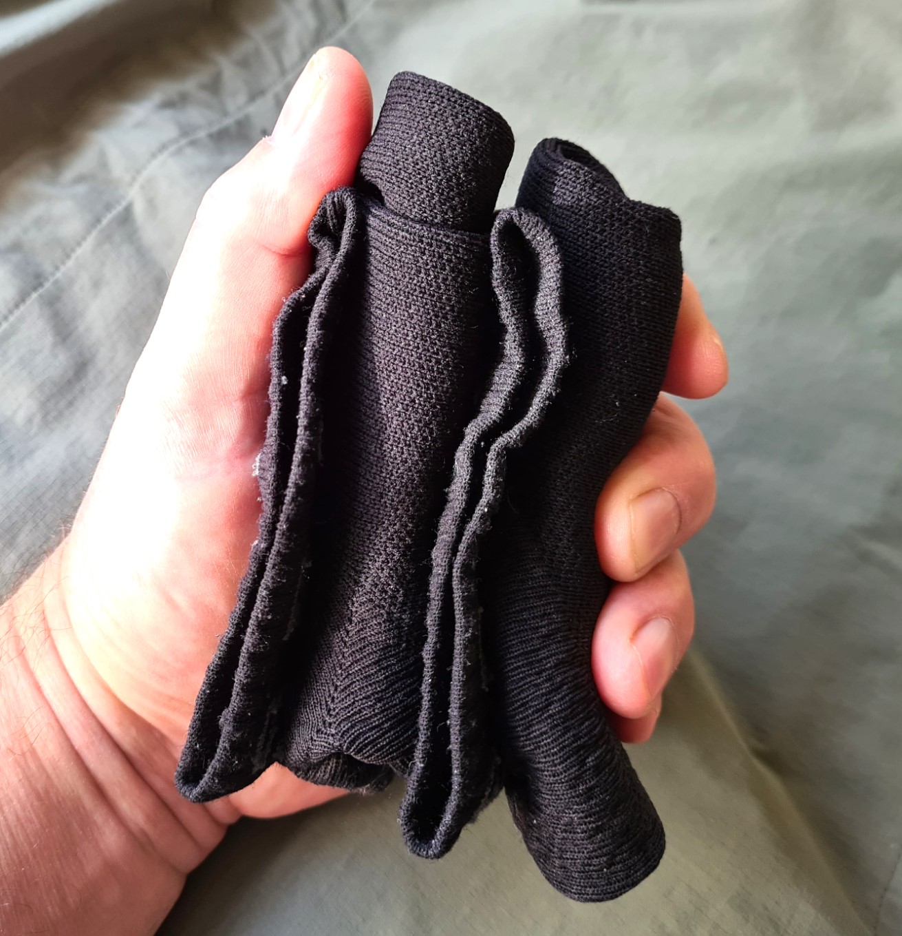 A pair of rolled Sealskinz socks takes up little room. One of the least bulky of camp shoe options