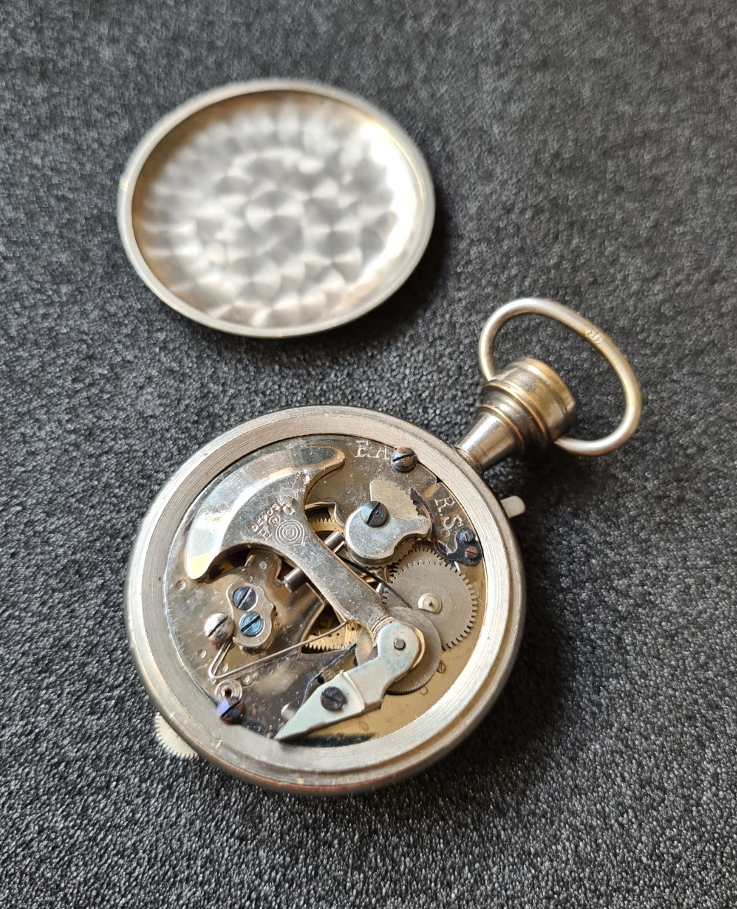 Removing the back of the case reveals not only the movement, but also the maker