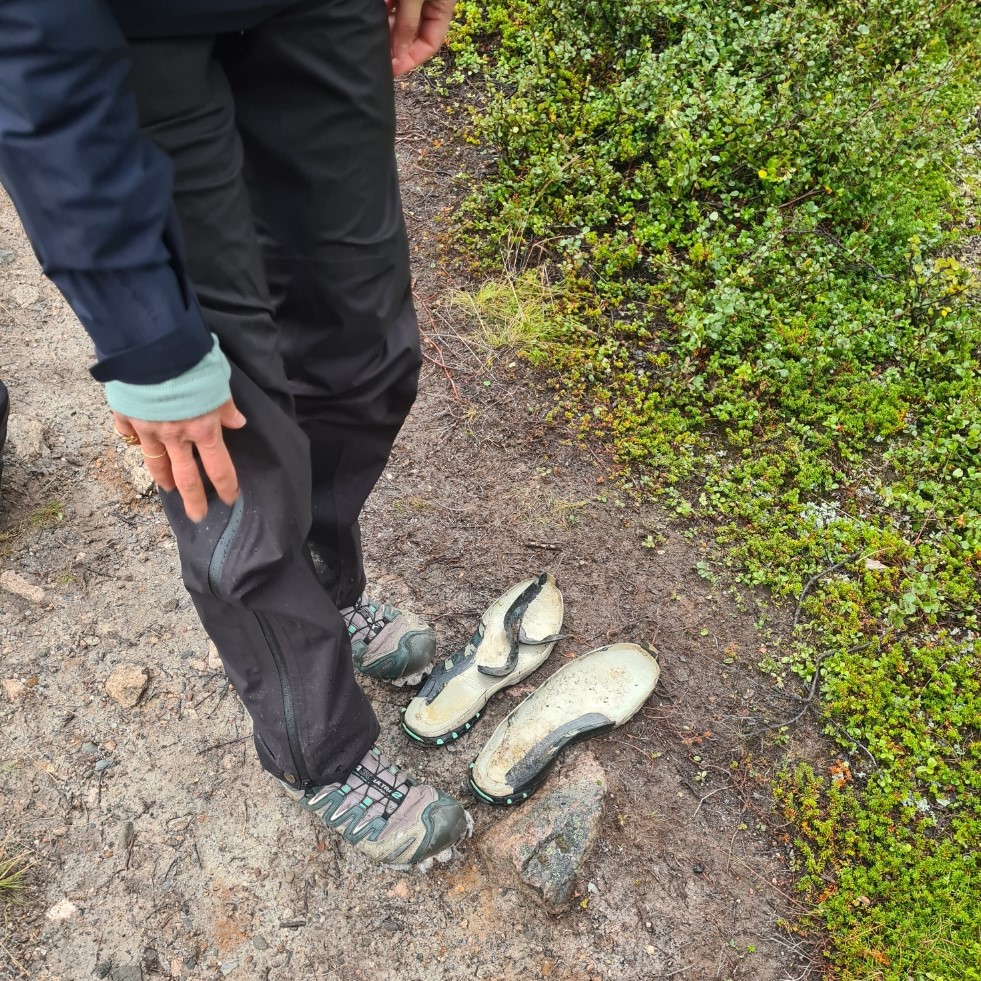 The rocky paths can be punishing to footwear. This hiker at Kebnekaise checkpoint had already lost both soles from her Salomon trail shoes