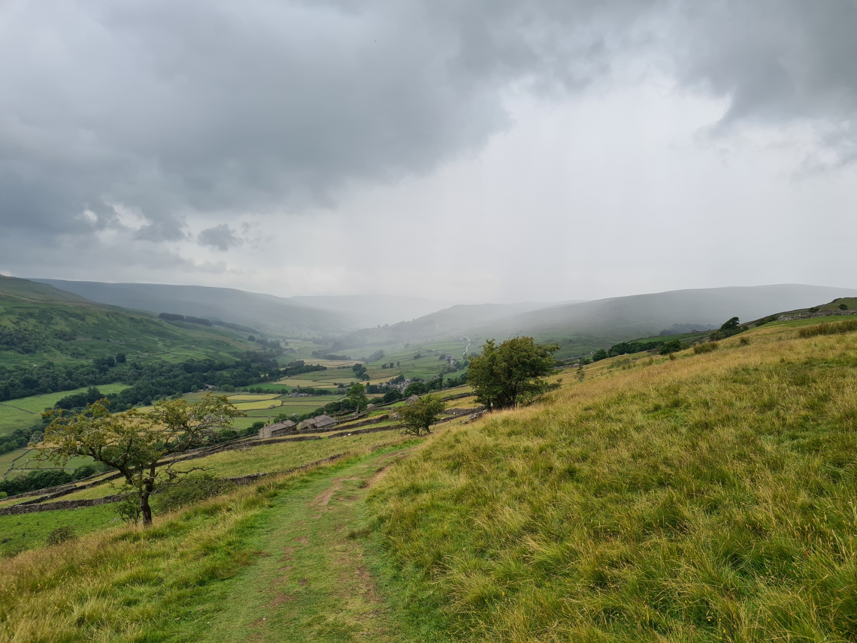 Rain moves up the valley from behind