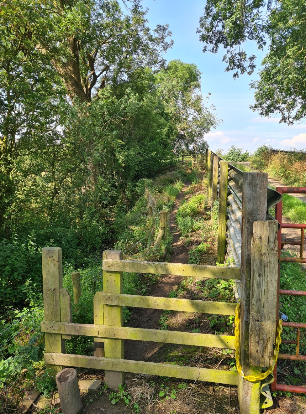 Three broken stiles and barbed wire to pass a single gate