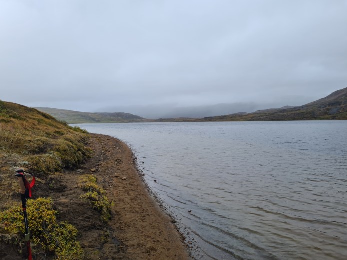 Following the lakeside path toward the outflow into the Kangerluarsuk Tulleq fjord beyond